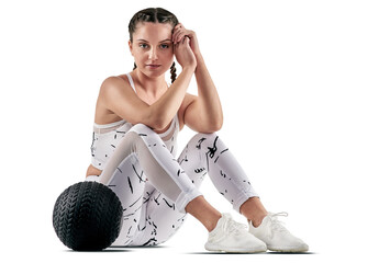 PNG studio portrait of a sporty young woman posing with an exercise ball.