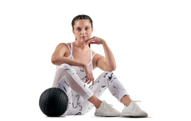 PNG studio portrait of a sporty young woman posing with an exercise ball.