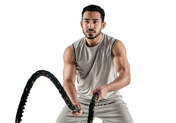 PNG studio shot of a muscular young man exercising with battle ropes.