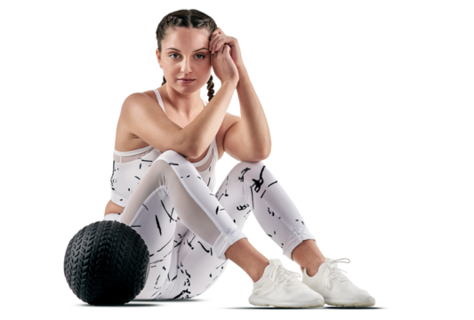 PNG studio portrait of a sporty young woman posing with an exercise ball.