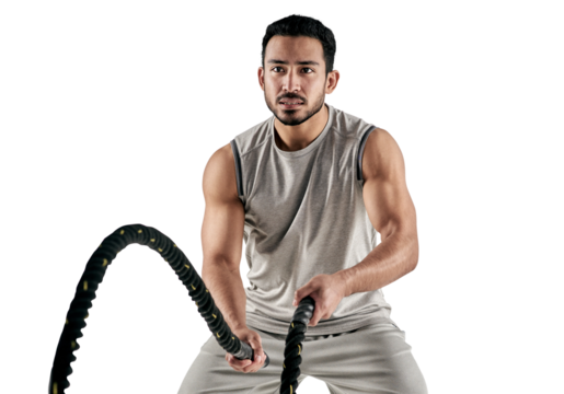 PNG studio shot of a muscular young man exercising with battle ropes.
