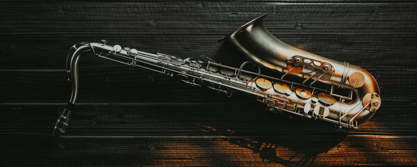 saxophone top view on a black wooden