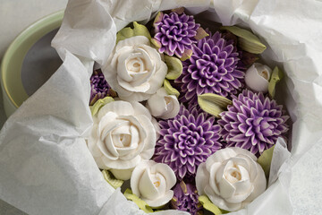Zephyr bouquet of flowers in a gift box on a light background