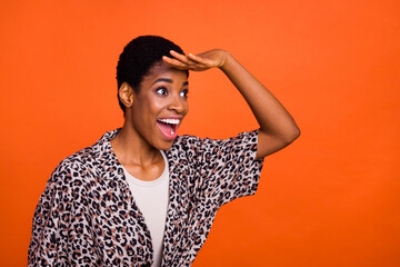 Profile portrait of shocked excited person hand forehead look empty space isolated on orange color background