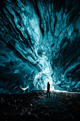 Fototapeta premium Person is standing in beautiful ice cave in Vatnajkull glacier Iceland in the winter