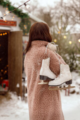 Girl with skates on her shoulder