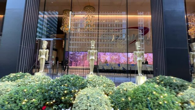 Row of golden nutcracker toy soldiers standing to attention outside New York city Christmas