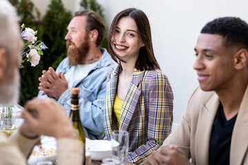 Family and friends celebrating at dinner on a rooftop terrace