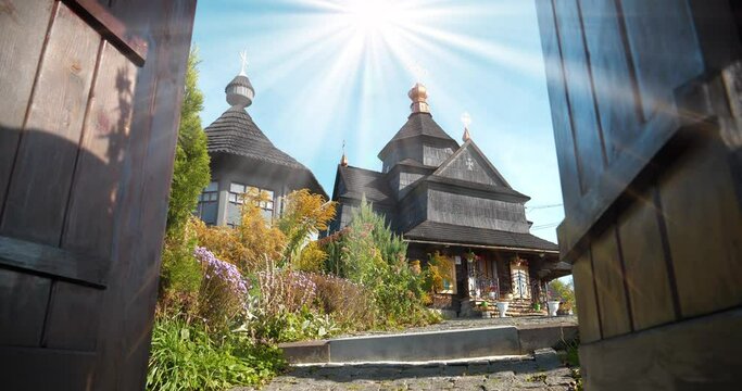 Divine radiance over Church of the Nativity of the Blessed Virgin Mary of 17-18 centuries in Vorokhta, western Ukraine, Carpathians. Church belongs to Hutsul school of traditional temple building