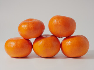 Ripe tangerines close-up on a white background.