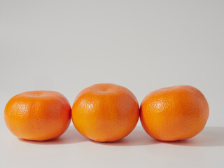 Ripe tangerines close-up on a white background.