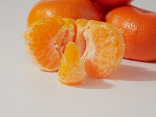 Ripe tangerines close-up on a white background.