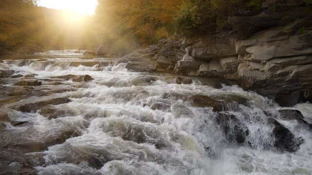 Beautiful powerful waterfall and amazing sunset. UHD 4K 60fps one minute relax video with water noise
