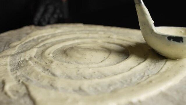 The chef puts the sauce on the pita bread. Shawarma preparation