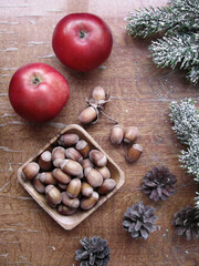 Fototapeta na wymiar Plate with nuts and red apples