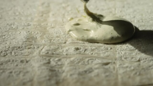 Lavash for shawarma, the cook spreads the sauce