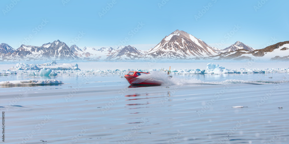 Wall mural fast moving motorboat trying to get out of the ice - stranded icebergs in the fog at the mouth of th
