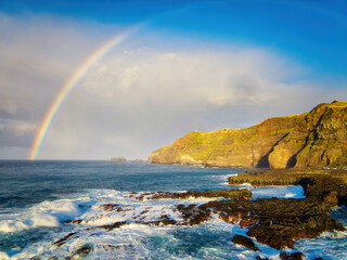 Obraz premium Coastal view and Atlantic Ocean with rainbow, Ponta da Ferraria, Sao Miguel island, Azores, Portugal