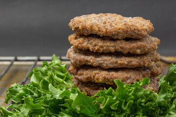 Fried burgers on lettuce leaves. Close up.