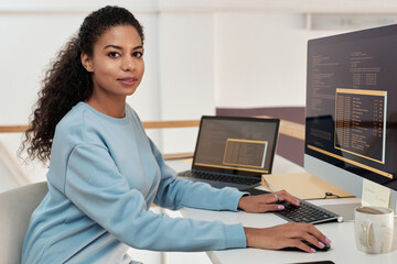 Portrait of female programmer working on computer in modern office of IT company