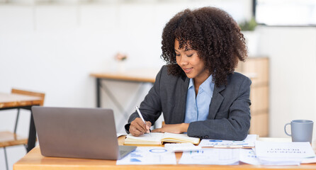Portrait young african american girl woman working on laptop computer in office. documents tax business planning analyzing the financial report, business plan investment, finance analysis concept.