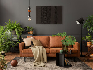 Creative composition of living room interior with mock up poster frame, brown sofa, plants in flowerpots, black coffee table, pillows, plaid, carpet and personal accessories. Home decor. Template.