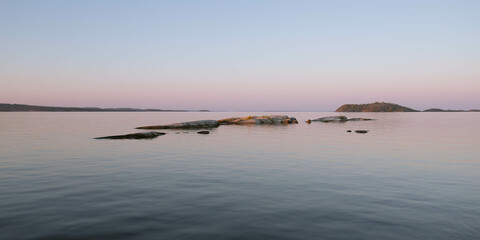 Rocks inhabited with birds on a lake in norther Europe