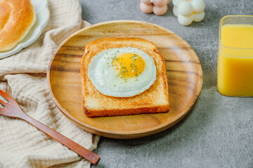 Fried egg crispy toast food on wood plate