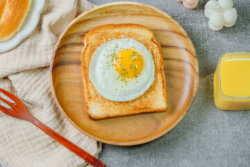 Fried egg crispy toast food on wood plate