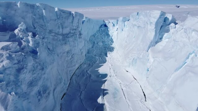 Frozen south pole. Desert white land of snow and ice drone shot. Snow covered antarctic surface aerial view flight. 