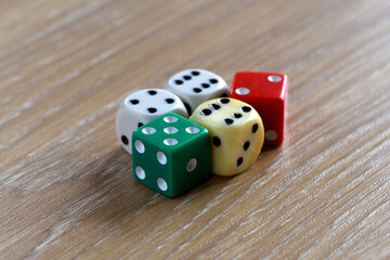 Old coloured dice on a table
