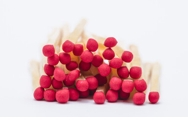 Pile of new unlit wooden matchsticks on white background