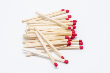 Pile of new unlit wooden matchsticks on white background