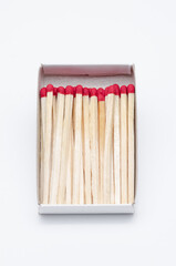 Set of new unlit matchsticks in a cardboard box on white background