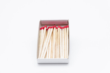 Set of new unlit matchsticks in a cardboard box on white background