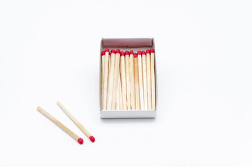Set of new unlit matchsticks in a cardboard box on white background