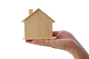 Wooden house model, in hand, white backgroundWooden house model,