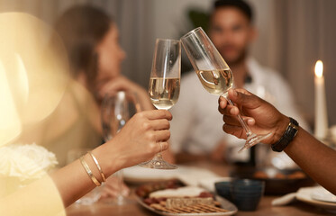 Closeup, champagne and glasses for celebration, party or friends enjoy New Years dinner or drinks together. Hands, toast and alcohol for drinking, event and food for social gathering, cheers or relax