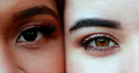 Two diverse different women close-up eyes opening