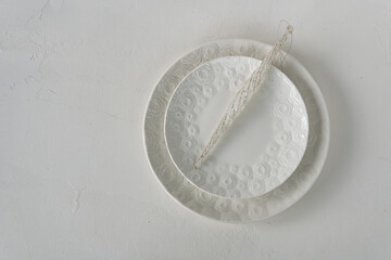 Christmas festive table setting with red decorations and checkered towel on white background. View from above. Copy space. Xmas dinner. Template for festive menu.