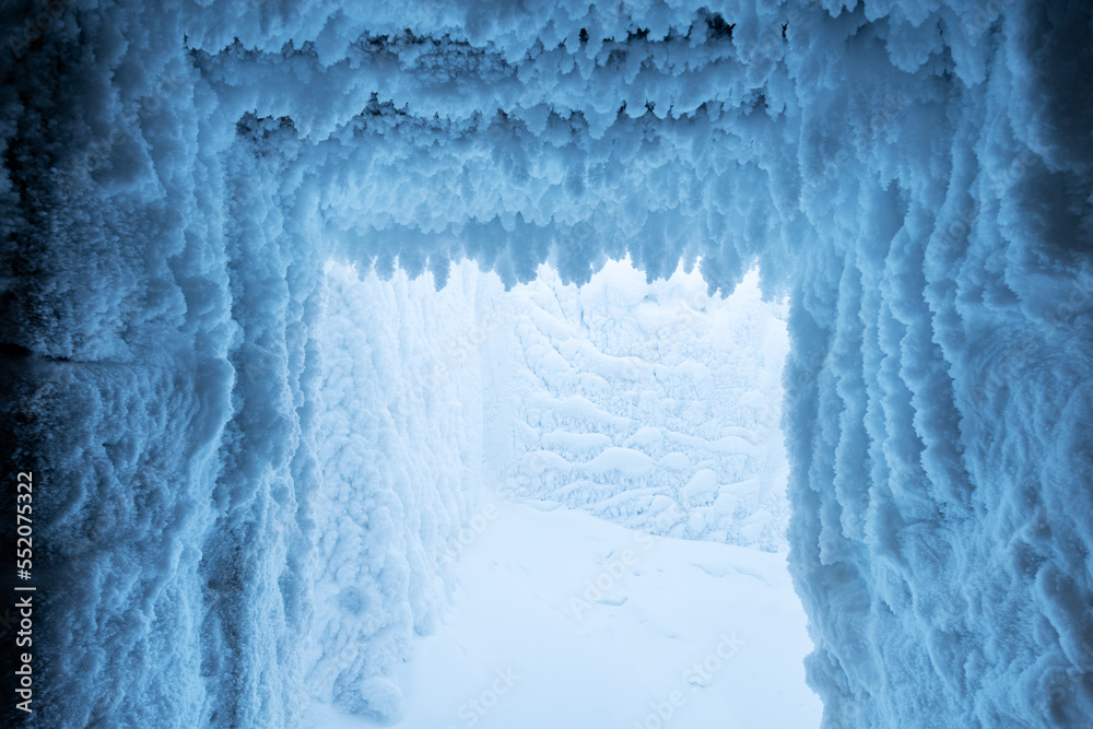 Wall mural winter christmas background of frozen snow growths on the ceiling and wall of the snow cave. winter 