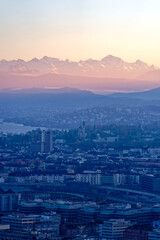 Aerial view over City of Zürich with Lake Zürich and Swiss Alps in the background on a sunny autumn evening. Photo taken December 6th, 2022, Zurich, Switzerland.