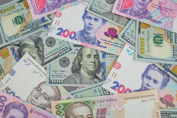 Fototapeta na wymiar Dollars and hryvnia as a background.