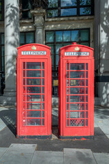 Two red classic british phone boxes in London, UK