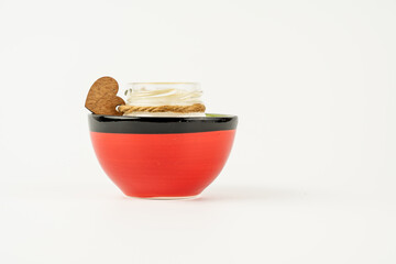 scented candle glass jar in a spanish clay bowl isolated on a white background