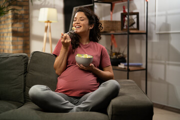 Pregnant woman eating fuit at home. Beautiful pregnant woman enjoy in healthy meal