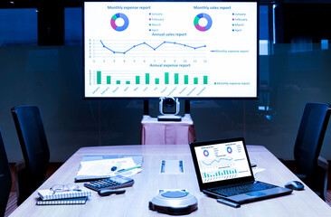 Mock up presentation on display television and laptop on table in meeting room