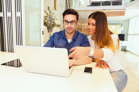 Young Entrepreneurs Working at the Office and Looking at a Laptop