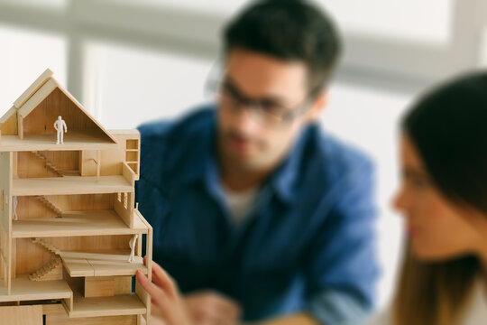 Young architects working on a wooden model