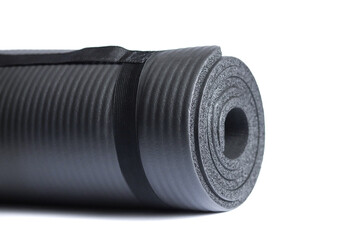 Gray yoga mat isolated on a white background. Сoncept of fitness equipment.